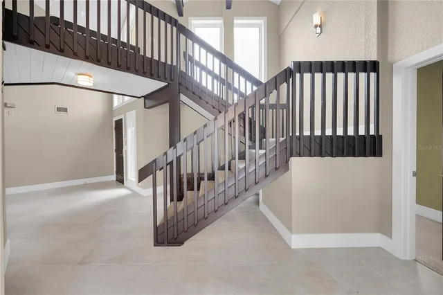 a living room with furniture and a floor to ceiling window