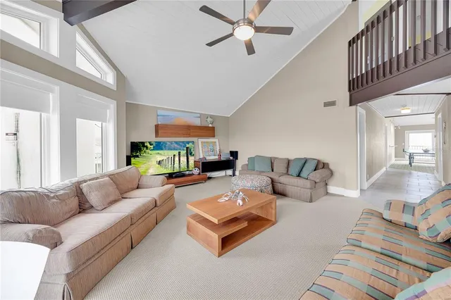 a kitchen with stainless steel appliances granite countertop a refrigerator a sink dishwasher a dining table and chairs with wooden floor