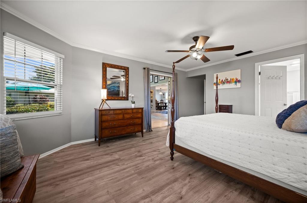 62 Lanai Circle, Unit 62 Naples, FL 34112 - Photo 19 of 30 a bedroom with a bed and a dresser