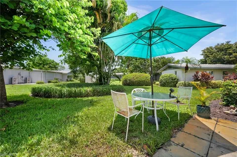a patio with a patio table and chairs