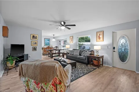a living room with furniture a rug and a flat screen tv