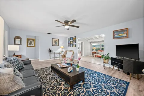 a living room with furniture a rug and a flat screen tv