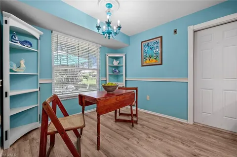 a work room with furniture and a chandelier