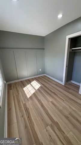 a view of empty room with wooden floor