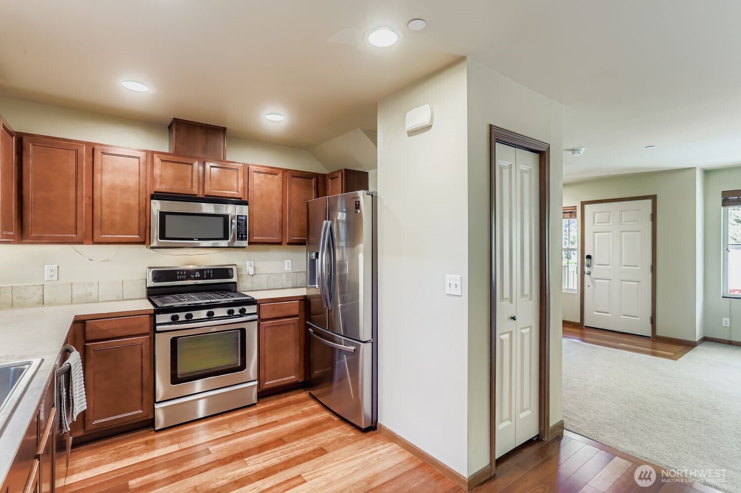 838 4th Avenue Northeast Issaquah, WA 98029 - Photo 9 of 26 a kitchen with granite countertop a refrigerator and a stove top oven