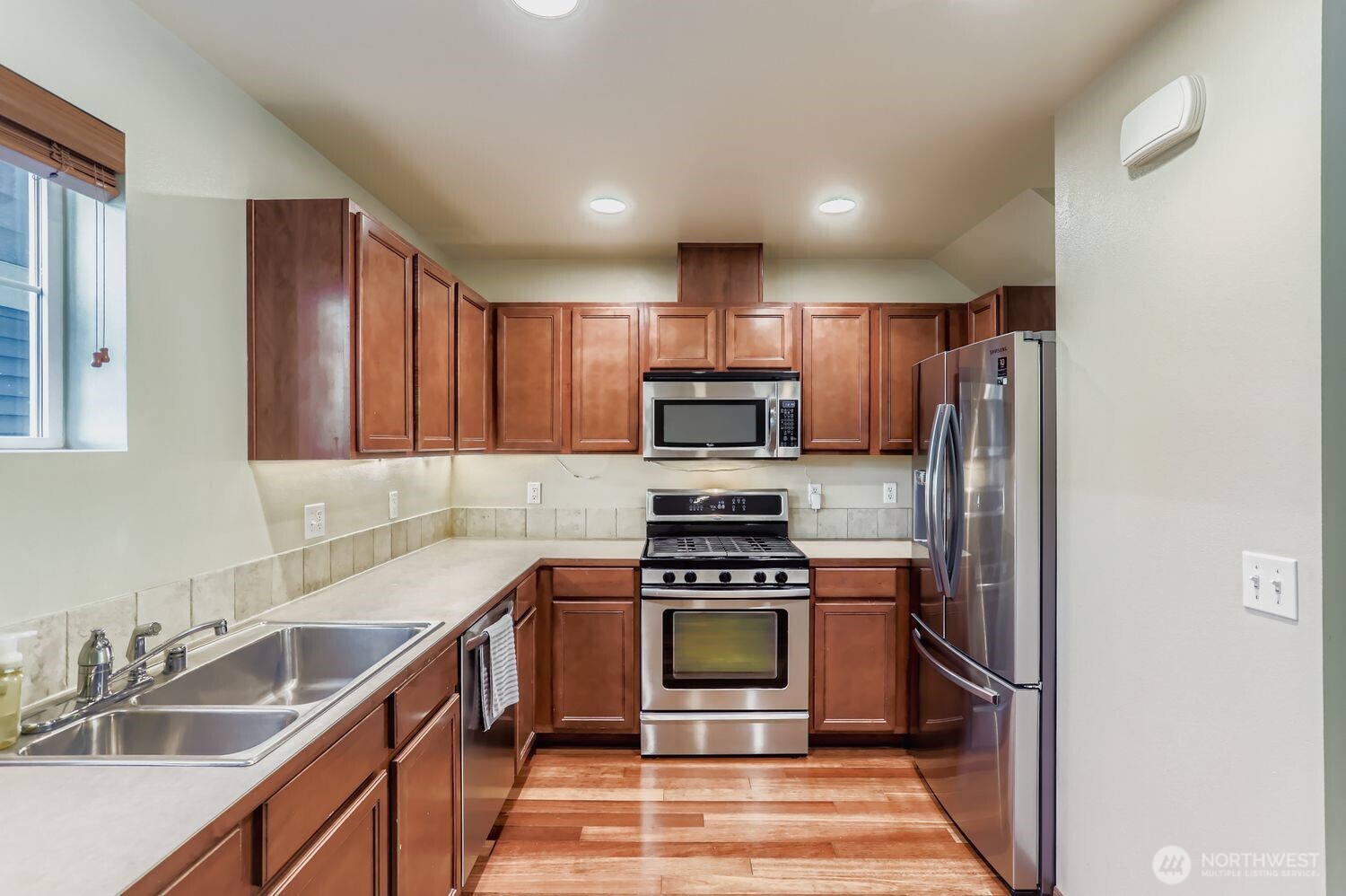 838 4th Avenue Northeast Issaquah, WA 98029 - Photo 10 of 26 a kitchen with stainless steel appliances a refrigerator sink and microwave