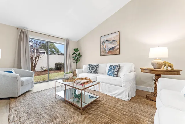 a living room with furniture and a floor to ceiling window
