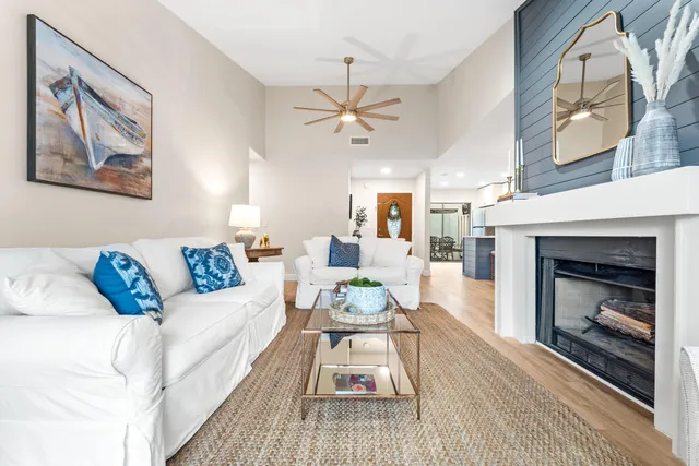 a living room with furniture a fireplace and a table