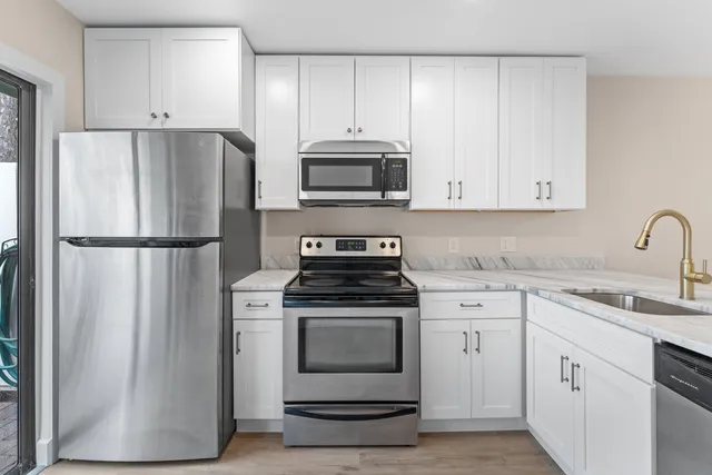 a kitchen with a stove microwave and refrigerator