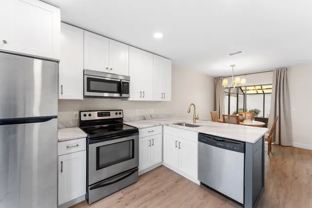 a kitchen with a sink stove and refrigerator