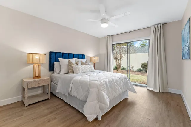 a large bedroom with a bed and large window