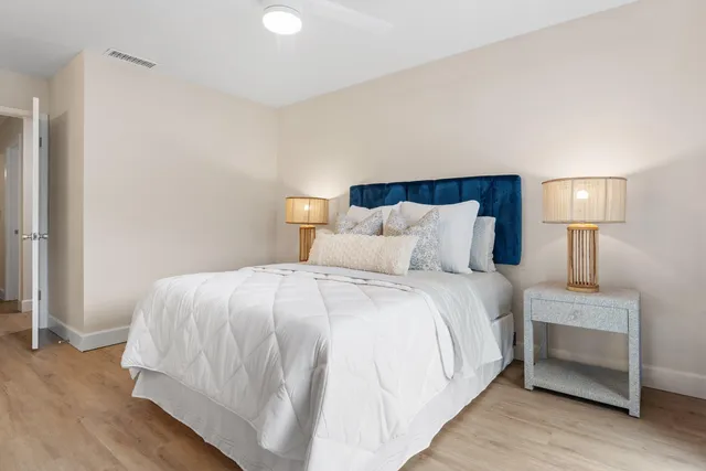 a bedroom with a bed and a night stand