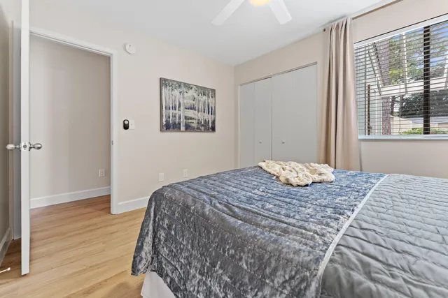 a bedroom with a bed and a window