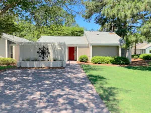 a view of house with swimming pool outdoor seating