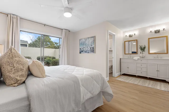 a bedroom with a bed and a large window