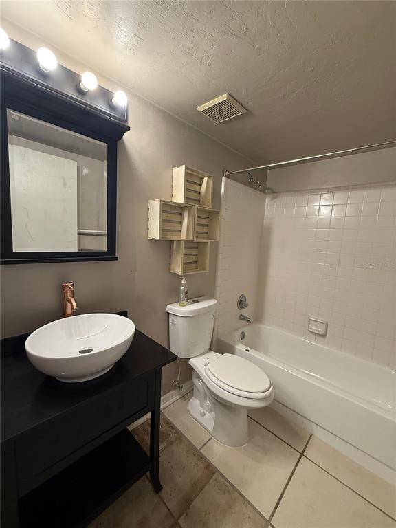 7200 Southwest 8th Avenue, Unit T128 Gainesville, FL 32607 - Photo 18 of 38 a bathroom with a toilet a sink and mirror