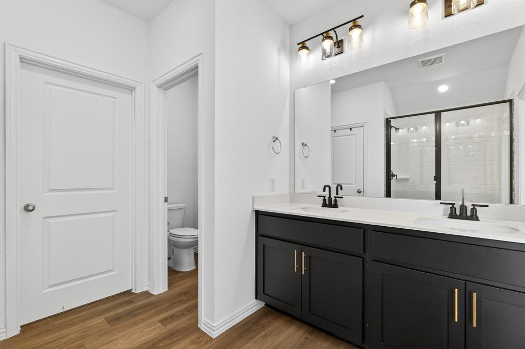 2325 Myrtle Way Melissa, TX 75454 - Photo 13 of 22 a bathroom with a double vanity sink and a mirror