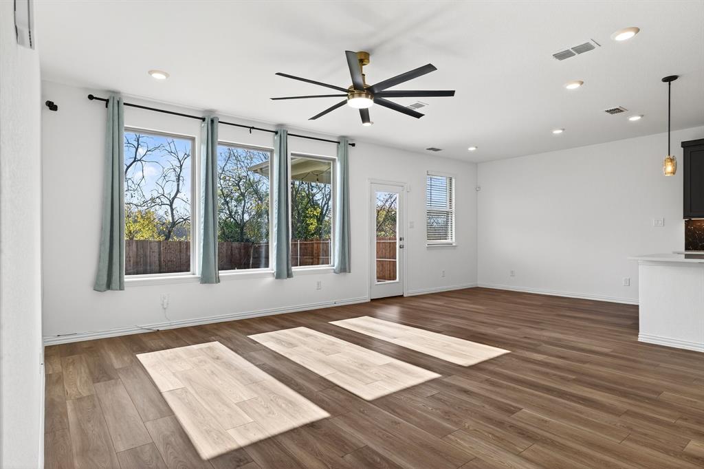 2325 Myrtle Way Melissa, TX 75454 - Photo 16 of 22 a view of an empty room with wooden floor and a window