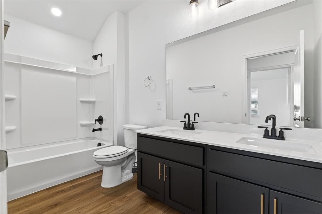 2325 Myrtle Way Melissa, TX 75454 - Photo 10 of 22 a bathroom with a sink toilet a mirror and shower