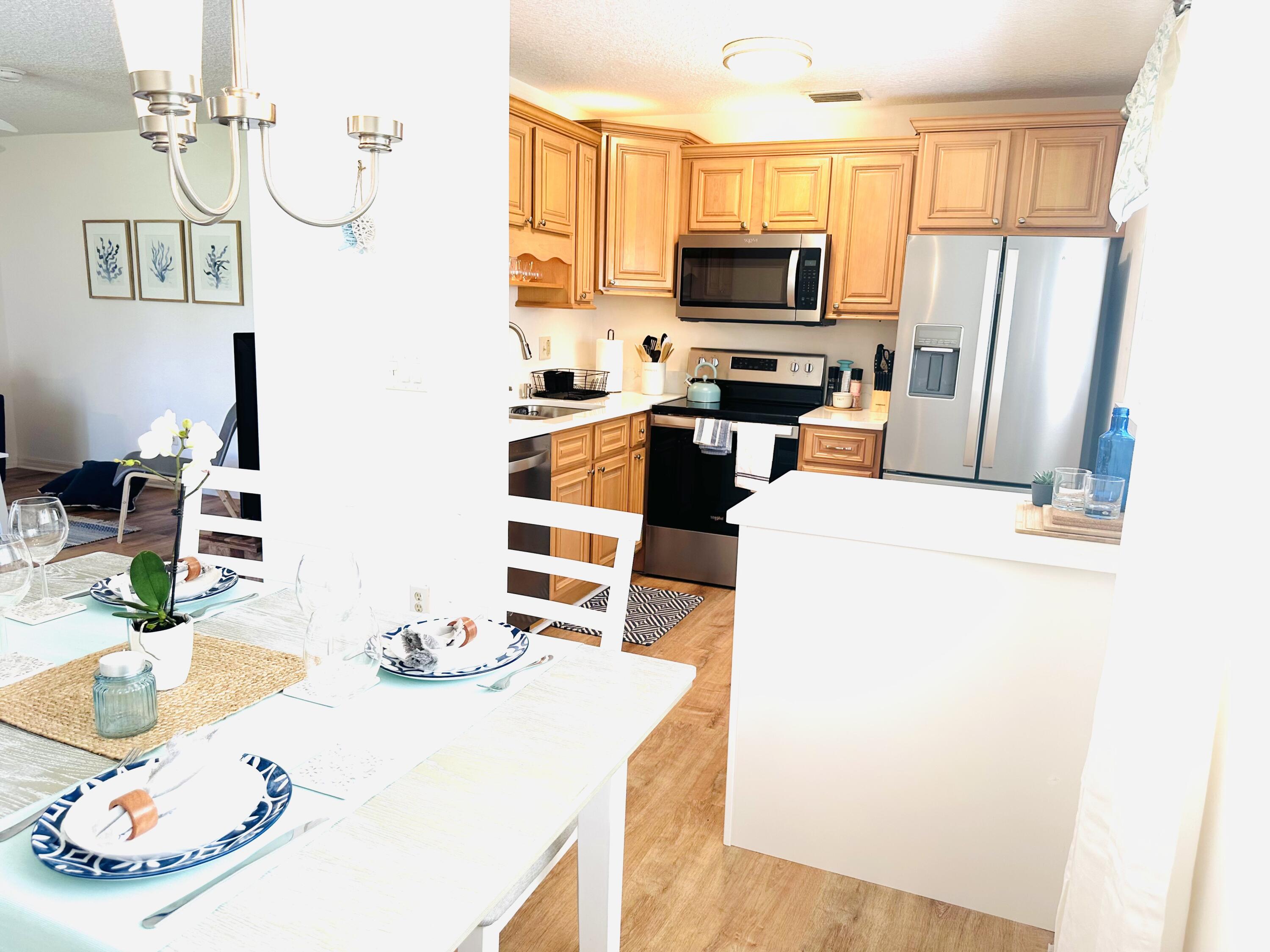 80 Crooked Tree Lane, Unit 106 Vero Beach, FL 32962 - Photo 15 of 47 a kitchen with a sink a stove and refrigerator