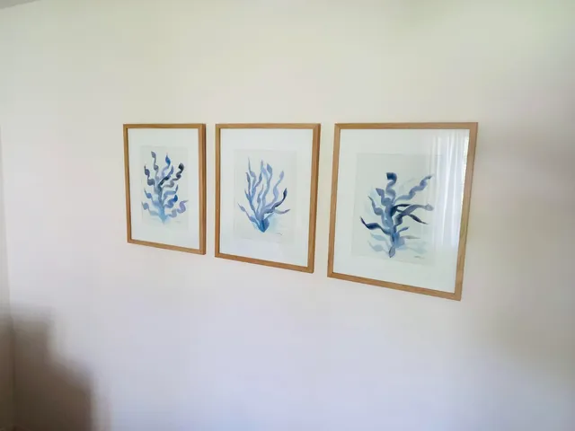 a white wall with a painting on the wall