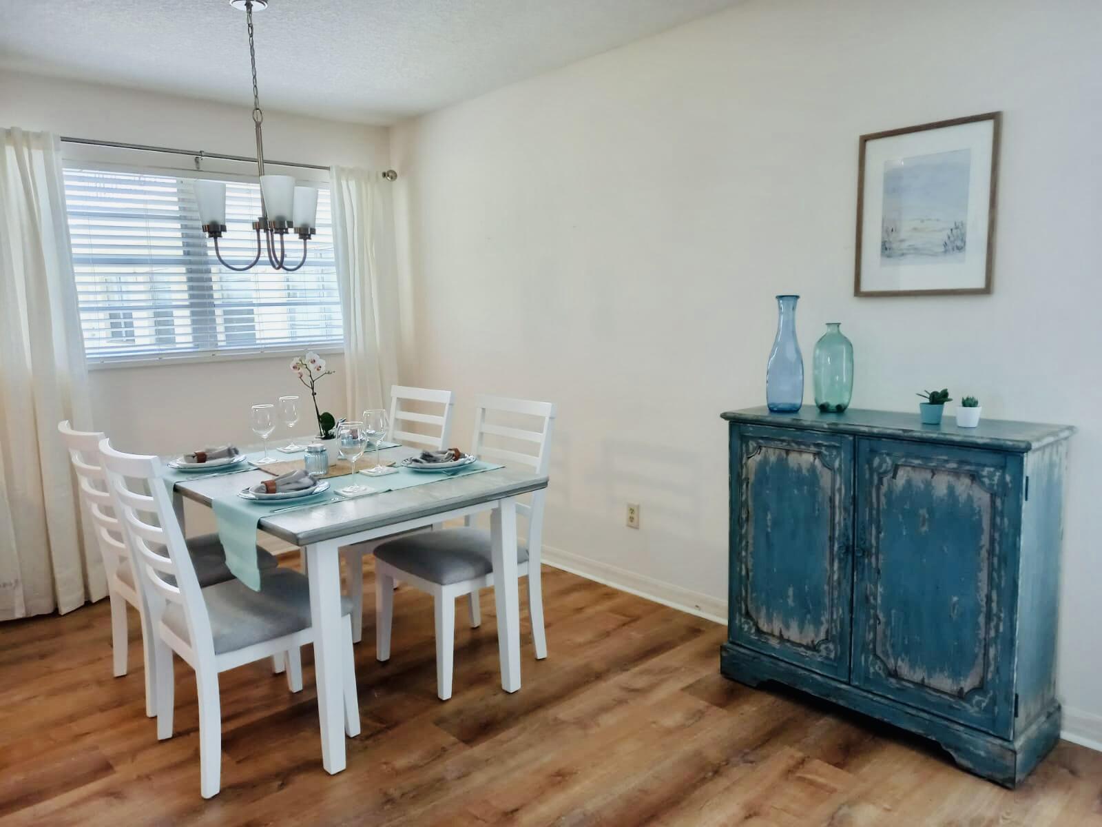 80 Crooked Tree Lane, Unit 106 Vero Beach, FL 32962 - Photo 25 of 47 a dining room with furniture and wooden floor