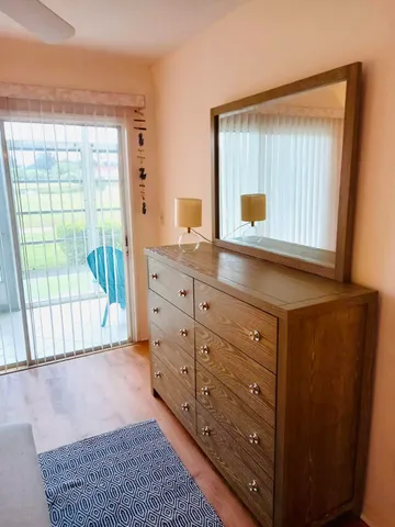 a room with a dresser and a window