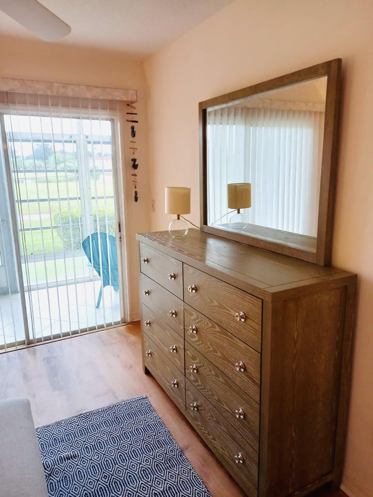 80 Crooked Tree Lane, Unit 106 Vero Beach, FL 32962 - Photo 31 of 47 a room with a dresser and a window