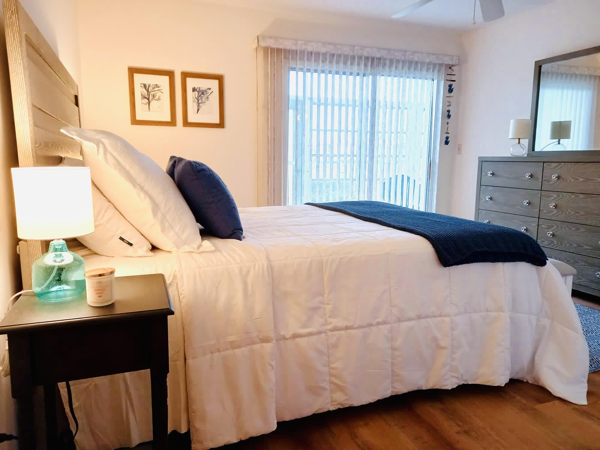 80 Crooked Tree Lane, Unit 106 Vero Beach, FL 32962 - Photo 35 of 47 a bedroom with a bed and wooden floor