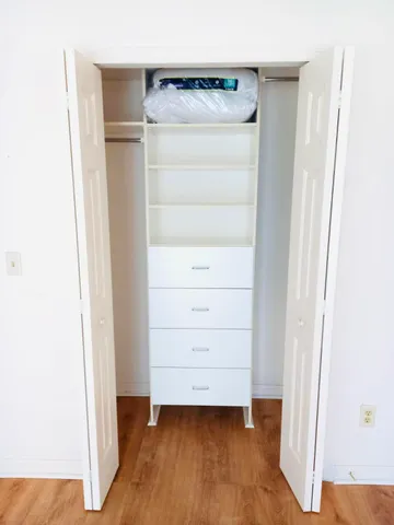 a view of walk in closet with empty racks