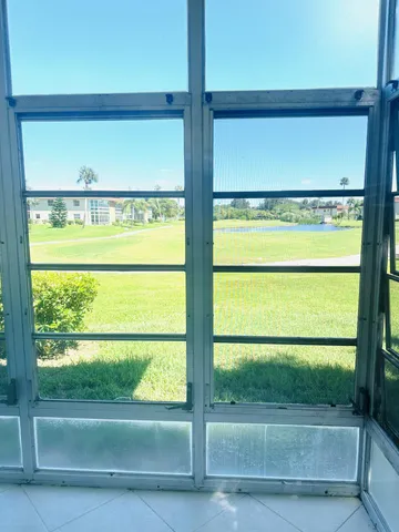 a view of a glass door with a yard from a window