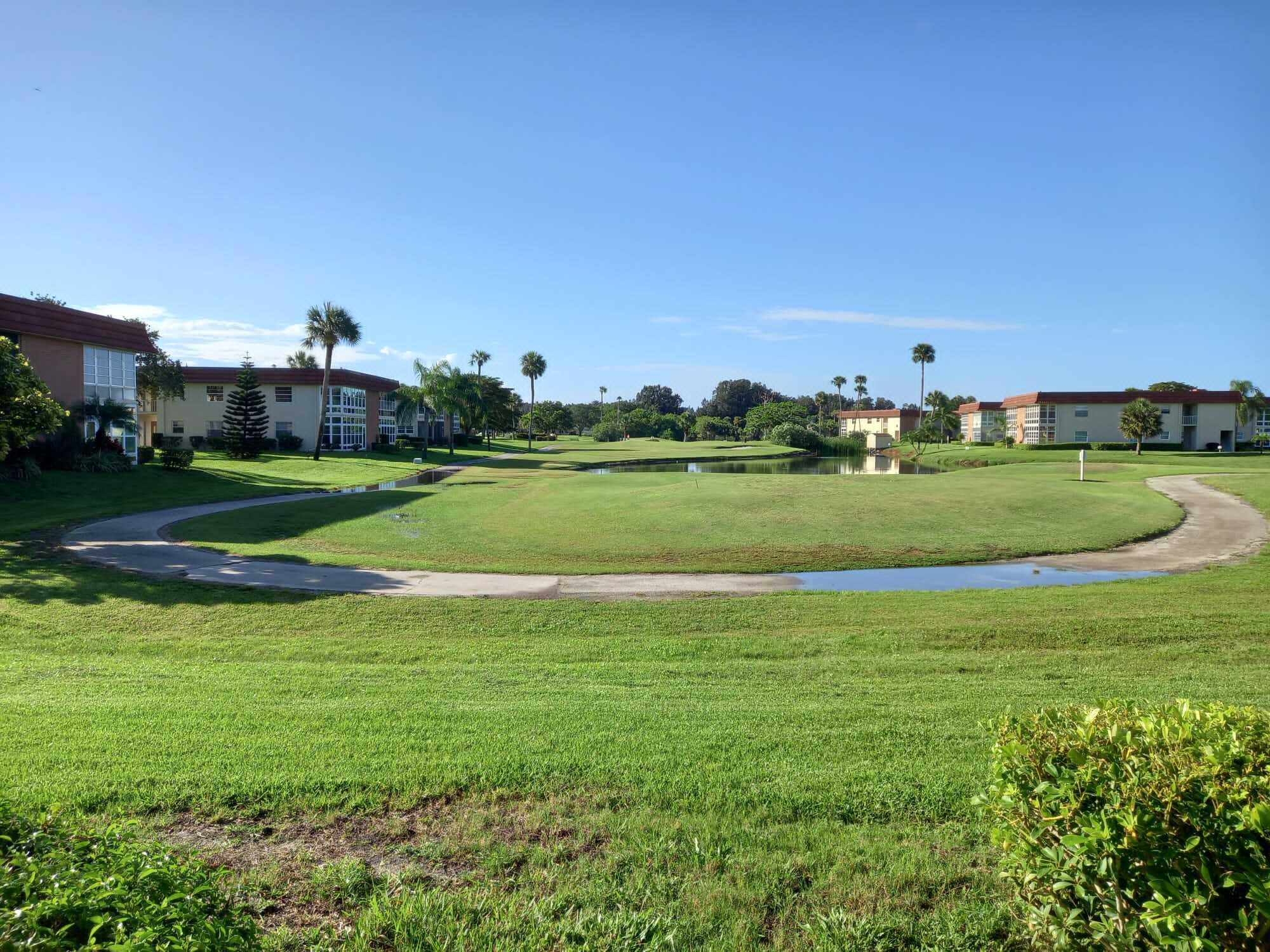80 Crooked Tree Lane, Unit 106 Vero Beach, FL 32962 - Photo 47 of 47 a view of a big room with a big yard and potted plants