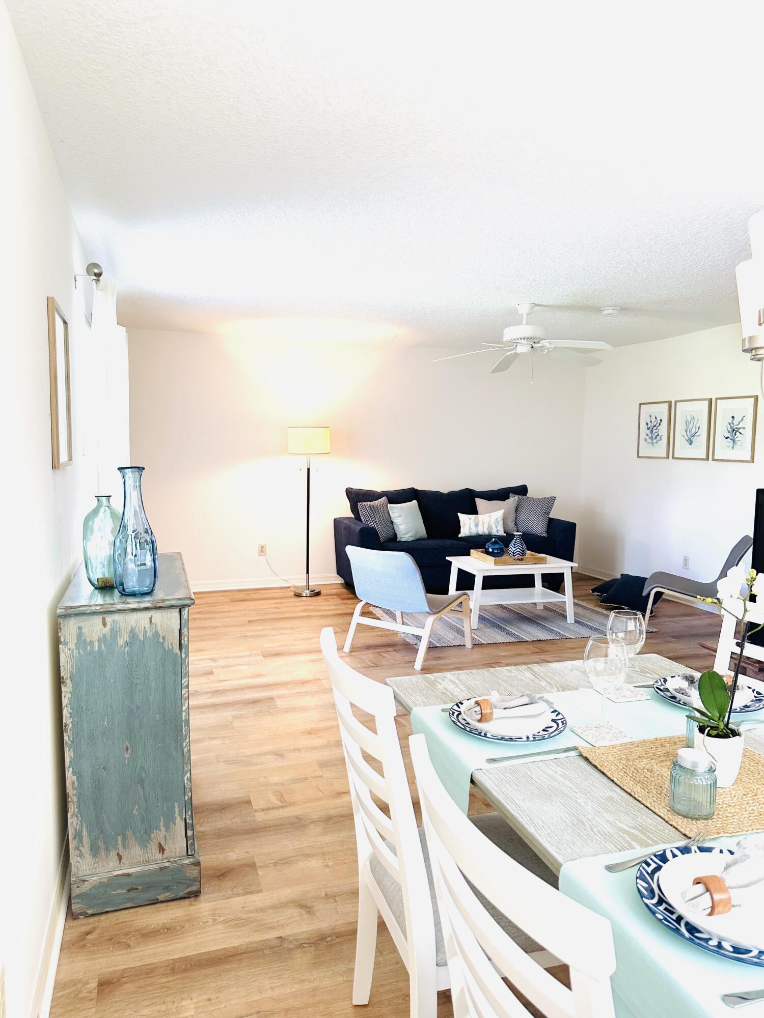 80 Crooked Tree Lane, Unit 106 Vero Beach, FL 32962 - Photo 9 of 47 a living room with furniture and flat screen tv