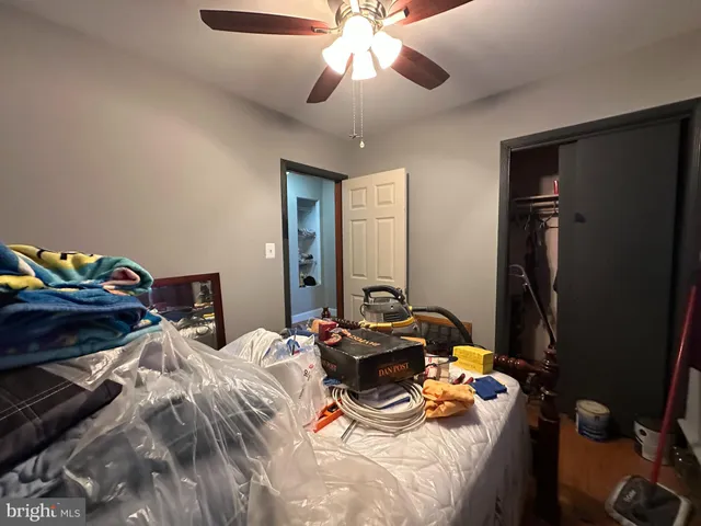 a bedroom with bed and a chandelier