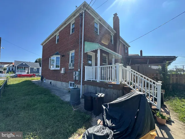 a view of a house with backyard porch and sitting area