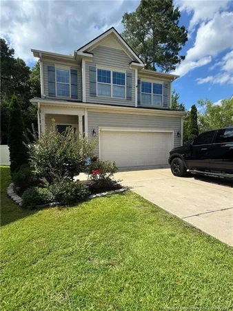 a front view of a house with a yard and garage