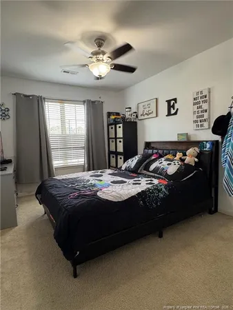 a bedroom with bed and window