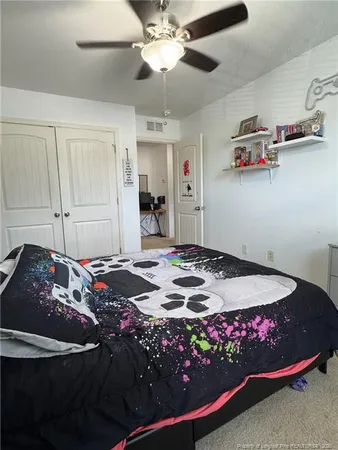 a living room with a bed furniture and a large window