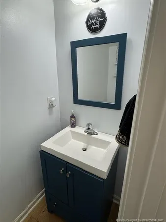 a bathroom with a sink a mirror and vanity