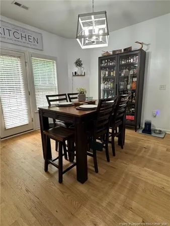a view of a dining room with furniture and chandelier