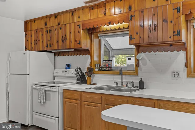a kitchen with stainless steel appliances granite countertop a sink and cabinets