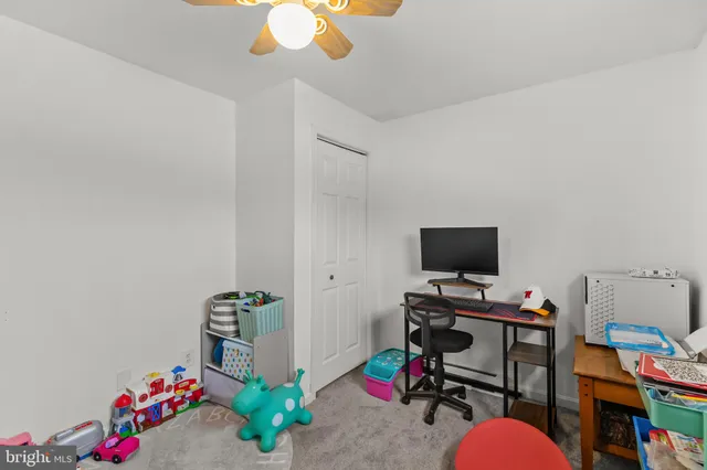 a view of a workspace with furniture and toys