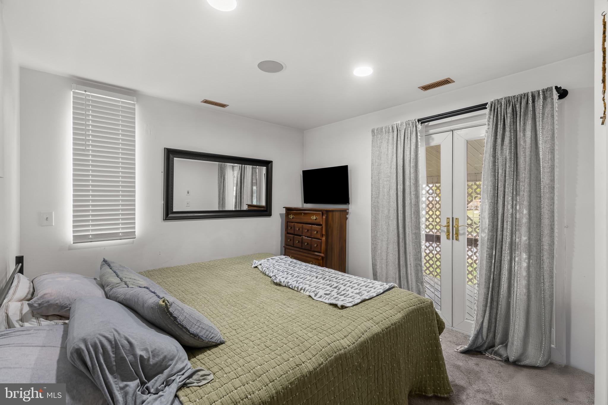 6913 River Drive Road Baltimore, MD 21219 - Photo 21 of 32 a bedroom with a bed and a flat screen tv