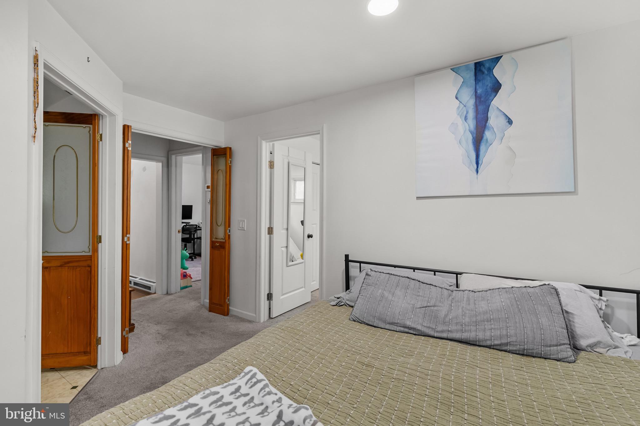 6913 River Drive Road Baltimore, MD 21219 - Photo 22 of 32 a bedroom with a bed and glass door