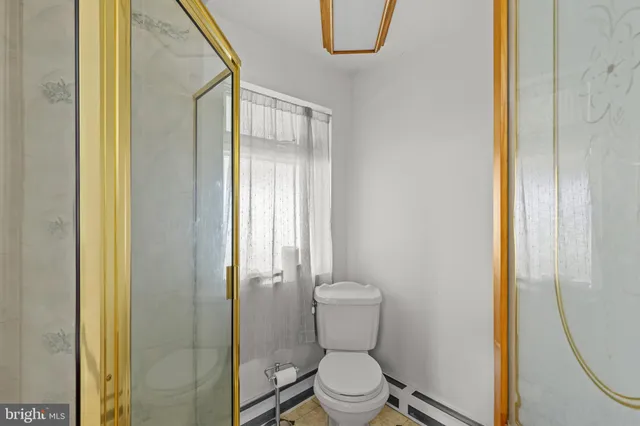 a white toilet sitting next to a bathroom sink