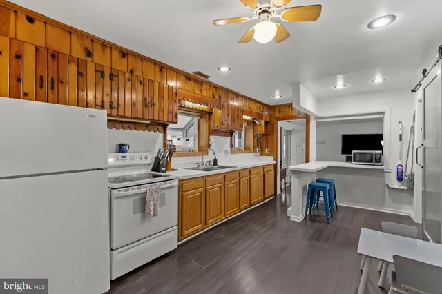 a kitchen with furniture a sink and a stove