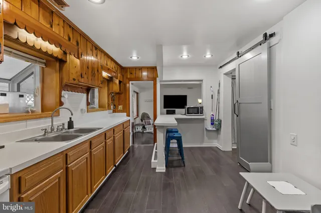 a kitchen with stainless steel appliances a sink stove and refrigerator