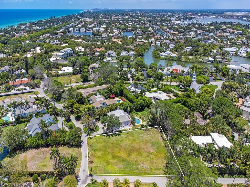 2545 Lantern Lane Naples, FL 34102 - Photo 1 of 5 an aerial view of residential houses with outdoor space