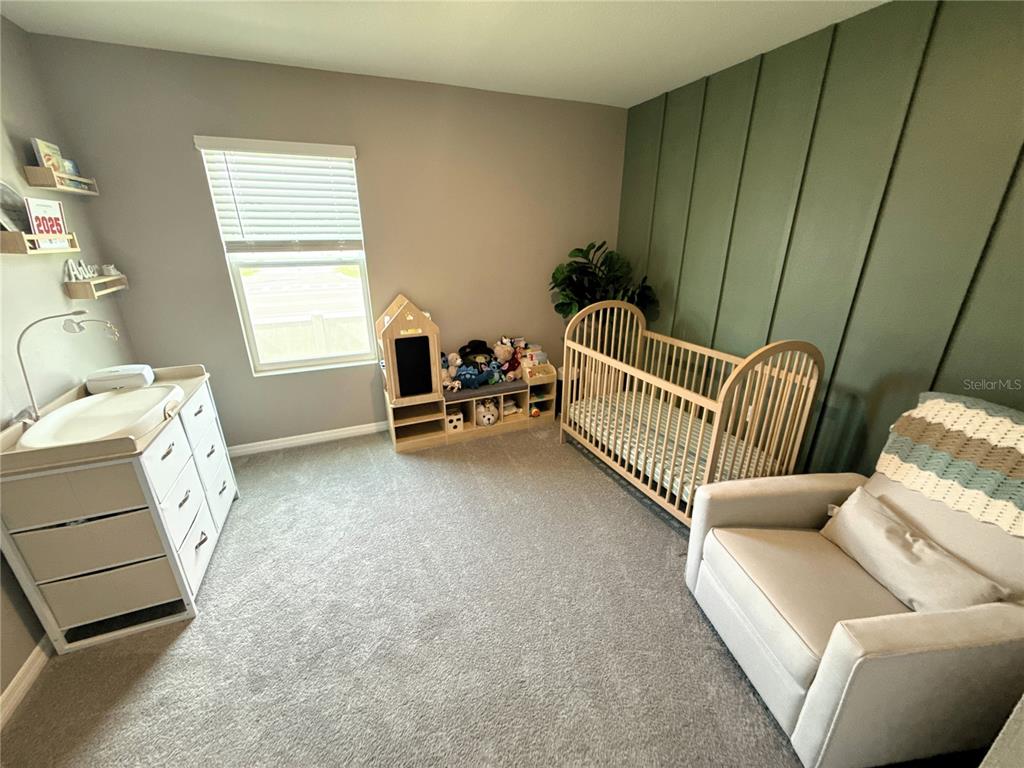 8446 Hardy Bay Loop Wesley Chapel, FL 33545 - Photo 17 of 38 a bedroom with furniture and a window