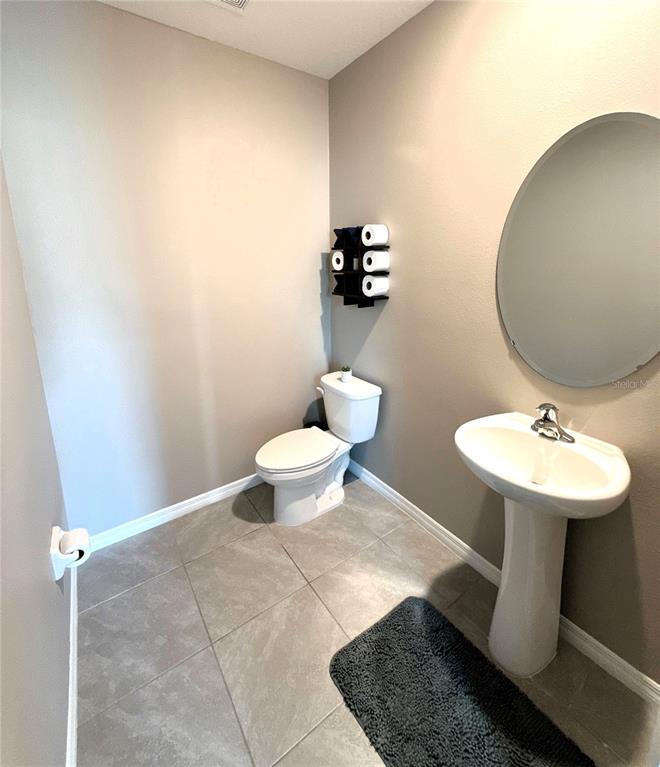 8446 Hardy Bay Loop Wesley Chapel, FL 33545 - Photo 21 of 38 a bathroom with a sink toilet and a mirror